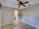 Bedroom with neutral walls, tile floors, a ceiling fan, and two closets at 10166 Cr 671, Bushnell, FL 33513