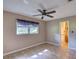Bedroom with neutral walls, tile floors, a ceiling fan, and natural light from the window at 10166 Cr 671, Bushnell, FL 33513
