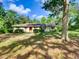 Charming single-story home features a classic design and inviting curb appeal with mature landscaping and traditional shutters at 10166 Cr 671, Bushnell, FL 33513