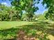 A charming single story home surrounded by a lush green landscape and mature trees at 10166 Cr 671, Bushnell, FL 33513