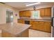 Well-equipped kitchen boasts ample cabinet space, tile floors, and a convenient center island, perfect for meal preparation at 10166 Cr 671, Bushnell, FL 33513