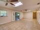 A sprawling living area features tile floors, lots of light, and multiple ceiling fans at 10166 Cr 671, Bushnell, FL 33513