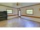 Spacious living room with neutral walls, tile flooring, and natural light from the windows at 10166 Cr 671, Bushnell, FL 33513