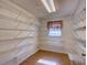Walk-in pantry featuring ample metal shelving for food storage and organization at 10166 Cr 671, Bushnell, FL 33513