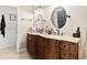 Bathroom featuring double vanity with marble countertop and decorative cabinetry at 10339 Patrick Dr, Leesburg, FL 34788