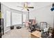 Bright bedroom with ceiling fan and ample natural light from large windows at 10339 Patrick Dr, Leesburg, FL 34788