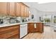 Bright kitchen featuring marble countertops, wood cabinets, and stainless steel appliances at 10339 Patrick Dr, Leesburg, FL 34788
