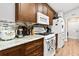 Well-lit kitchen with marble countertops, wooden cabinets, and modern appliances at 10339 Patrick Dr, Leesburg, FL 34788