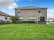 Spacious backyard with an immaculate lawn and privacy hedge that adds beauty to this modern two-story home at 1051 Nathan Ridge Rd, Clermont, FL 34715