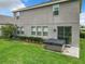 Backyard featuring a hot tub with a covered top next to a sliding door entry for the home at 1051 Nathan Ridge Rd, Clermont, FL 34715