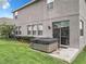 The backyard shows a hot tub near the rear entrance and a lush lawn at 1051 Nathan Ridge Rd, Clermont, FL 34715