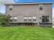 A wide-angle shot of the spacious backyard features a hot tub and lots of green space at 1051 Nathan Ridge Rd, Clermont, FL 34715