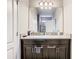 Bathroom featuring a double sink vanity with a large mirror and modern fixtures at 1051 Nathan Ridge Rd, Clermont, FL 34715
