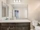 Bathroom featuring a vanity, toilet, and a doorway leading to another room at 1051 Nathan Ridge Rd, Clermont, FL 34715