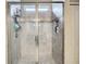 Modern bathroom shower with tiled walls, glass doors, and built-in shelving for convenient storage at 1051 Nathan Ridge Rd, Clermont, FL 34715