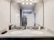 Bathroom featuring a double sink vanity with quartz countertops, and modern lighting fixtures at 1051 Nathan Ridge Rd, Clermont, FL 34715
