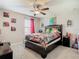 Bedroom features a ceiling fan, comic themed decor, and plush carpet flooring at 1051 Nathan Ridge Rd, Clermont, FL 34715