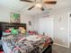 Bedroom featuring a ceiling fan, closet, and comic themed bedding at 1051 Nathan Ridge Rd, Clermont, FL 34715