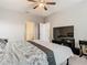 Bedroom featuring a large bed, ceiling fan, and a view into another room at 1051 Nathan Ridge Rd, Clermont, FL 34715