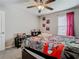 Well-lit bedroom with a window, comic themed bedding, and carpet flooring at 1051 Nathan Ridge Rd, Clermont, FL 34715