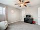 Bedroom with a ceiling fan, gray carpet, and natural light from a window at 1051 Nathan Ridge Rd, Clermont, FL 34715