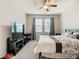 Bedroom showcasing a bed, ceiling fan, and windows with natural light at 1051 Nathan Ridge Rd, Clermont, FL 34715
