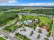 Aerial view showcasing the community center, recreational facilities, and surrounding lush landscape at 1051 Nathan Ridge Rd, Clermont, FL 34715