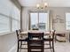 Cozy dining area features large window and stylish lighting at 1051 Nathan Ridge Rd, Clermont, FL 34715