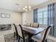 Bright dining space featuring a dark wood table, neutral decor, and a view of the outdoors at 1051 Nathan Ridge Rd, Clermont, FL 34715