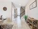 Inviting foyer with light tile flooring, staircase, and decor that creates a welcoming atmosphere at 1051 Nathan Ridge Rd, Clermont, FL 34715