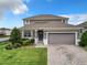 Charming two-story home with well-maintained landscaping and a two-car garage at 1051 Nathan Ridge Rd, Clermont, FL 34715