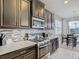 Well-appointed kitchen features granite counters, stainless appliances, and modern backsplash at 1051 Nathan Ridge Rd, Clermont, FL 34715