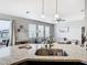 View of kitchen island, sink, and modern pendant lighting at 1051 Nathan Ridge Rd, Clermont, FL 34715