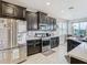 Updated kitchen with stainless appliances, granite countertops, and a view of the dining area at 1051 Nathan Ridge Rd, Clermont, FL 34715