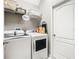 Laundry room equipped with a washer, dryer, and storage shelves for added convenience at 1051 Nathan Ridge Rd, Clermont, FL 34715