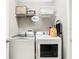 Well-equipped laundry room featuring a washer, dryer, and overhead shelving for supplies at 1051 Nathan Ridge Rd, Clermont, FL 34715