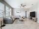 Spacious living room featuring bright natural light, a ceiling fan, and neutral color palette at 1051 Nathan Ridge Rd, Clermont, FL 34715