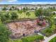 Aerial view of a community playground with slides and climbing structures, surrounded by a secure fence at 1051 Nathan Ridge Rd, Clermont, FL 34715