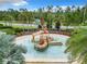 Aerial view of a splash pad with interactive water features and tropical palm trees at 1051 Nathan Ridge Rd, Clermont, FL 34715