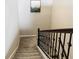 Staircase leading up to the second floor with carpeted stairs and decorative metal railings at 1051 Nathan Ridge Rd, Clermont, FL 34715
