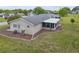 Aerial view of back of home with lanai, landscaping and mature trees in a quiet neighborhood at 10689 Se 174Th Loop, Summerfield, FL 34491