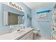 Charming full bathroom with blue walls, ample counter space, and decorative nautical accents at 10689 Se 174Th Loop, Summerfield, FL 34491