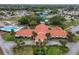 Aerial view showcasing a community clubhouse, swimming pool, tennis courts, and surrounding residential area at 10689 Se 174Th Loop, Summerfield, FL 34491