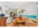 Bright dining area with wood floors, chandelier, and sliding glass doors leading to a screened porch with beachy mural at 10689 Se 174Th Loop, Summerfield, FL 34491