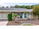 Inviting home exterior with a tidy yard, decorative shutters, and a cozy front porch area at 10689 Se 174Th Loop, Summerfield, FL 34491