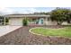 Charming single-story home with a well-manicured lawn, inviting front porch, and attached garage at 10689 Se 174Th Loop, Summerfield, FL 34491