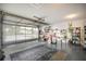 Spacious garage featuring epoxy floor, shelving, and natural light from the transparent garage door at 10689 Se 174Th Loop, Summerfield, FL 34491