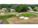 Scenic view of the golf course featuring well-manicured greens, bunkers, and lush trees at 10689 Se 174Th Loop, Summerfield, FL 34491