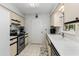 Well-lit kitchen with neutral cabinets, stainless steel appliances, and modern fixtures, creating an efficient workspace at 10689 Se 174Th Loop, Summerfield, FL 34491