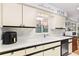 Well-lit kitchen with ample counter space, mosaic backsplash, and abundant cabinet storage, perfect for cooking enthusiasts at 10689 Se 174Th Loop, Summerfield, FL 34491